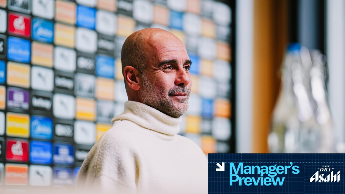 This image features a person with a blurred face standing in front of a backdrop covered in multicolored logos, likely at a press conference. A banner at the bottom reads 'Manager's Preview' sponsored by Asahi.