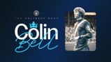 A tribute to Colin Bell, labeled as 'The Unlikely Hero.' The image includes a vintage football player with number 8 jersey, Manchester City logo, and decorative text.