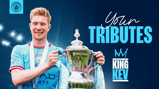 The image shows a Manchester City player holding a trophy with the text 'Your Tributes' and 'King Kev' over it. The Manchester City logo is visible at the top. The face of the player is blurred.