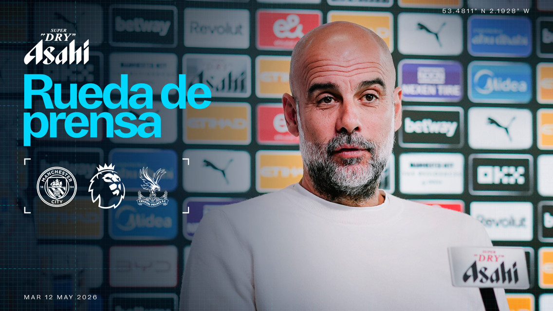 Blurred image of a person at a press conference for a match between Manchester City and Crystal Palace. Background includes brand logos and the Premier League logo. Date: 12 May 2026.