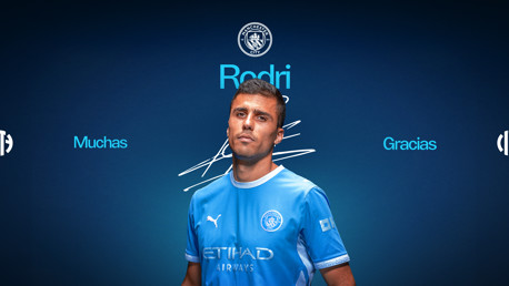 A Manchester City player in a team uniform stands against a blue background with the text 'Rodri', 'Muchas', and 'Gracias' surrounding them. The team's logo is visible above.