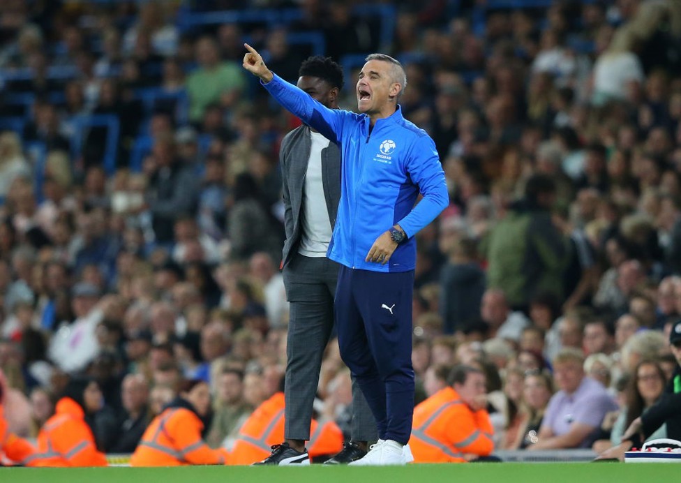 Take that! It's coach Robbie Williams