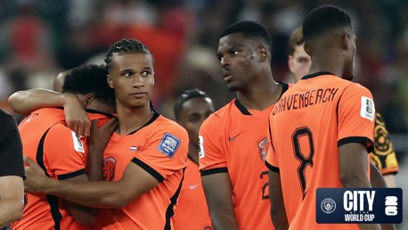 Dutch football players wearing orange jerseys with 'GRAVENBERCH' visible on one shirt, standing together at a World Cup event, with a 'CITY World Cup' logo in the corner.