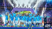Football team celebrating winning the FIFA Club World Cup 2023 in Saudi Arabia. Players in blue uniforms holding a trophy amid fireworks and confetti.