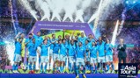 Football team celebrating winning the FIFA Club World Cup 2023 in Saudi Arabia. Players in blue uniforms holding a trophy amid fireworks and confetti.
