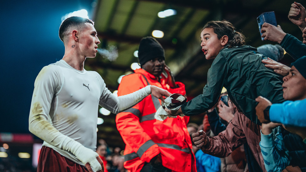 MEMORIES : Phil Foden gives a young City fan a memory to last a lifetime as he hands over his match shirt.