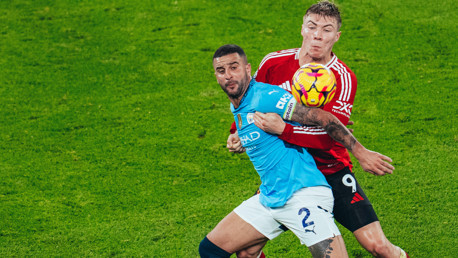BATTLE: Walker and Hojlund tussle for possession.