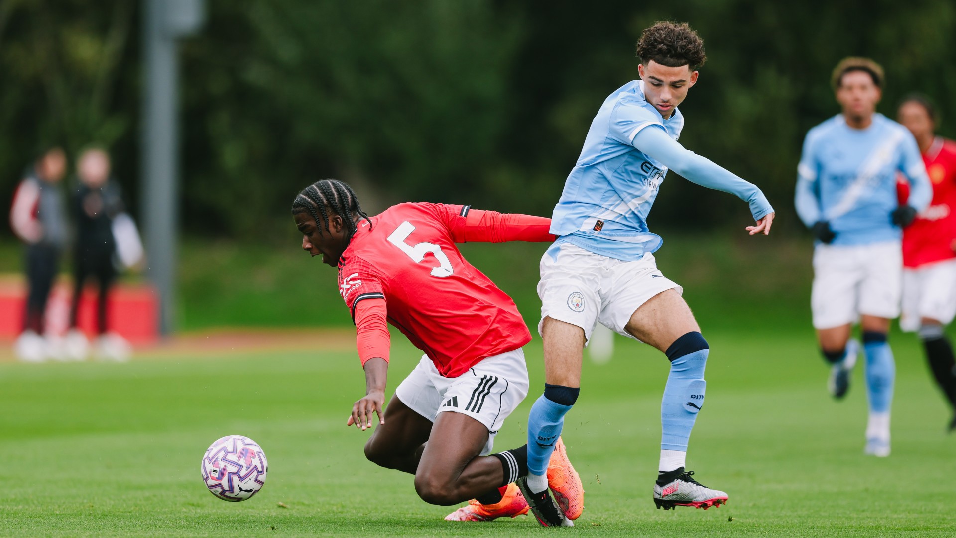 STUCK IN : Kylan Midwood and Godwill Kukonki challenge for the ball. 