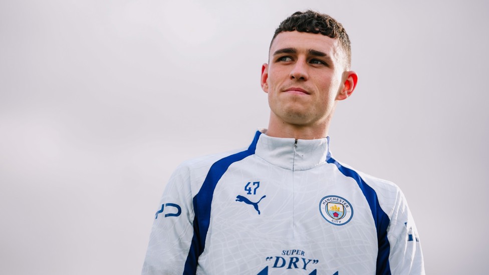 STEPPING OUT : Phil Foden makes his way to the training pitches.