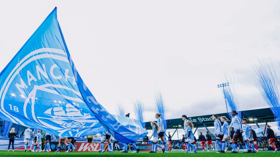 HERE WE GO : The players make their way out onto the pitch