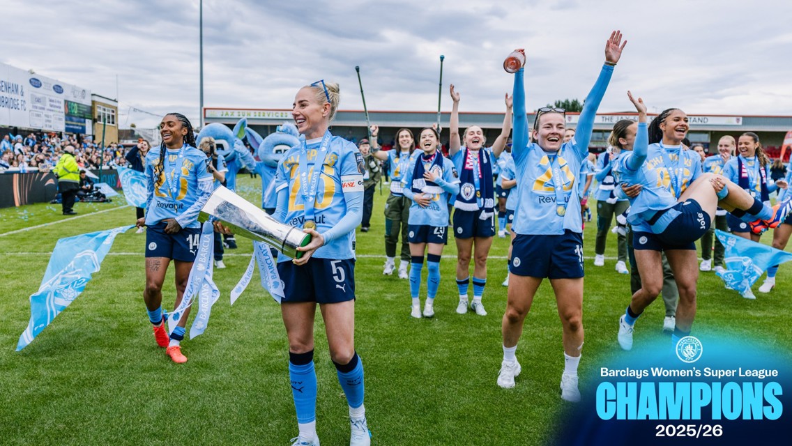 Manchester City Women's team celebrating Barclays Women's Super League 2025/26 championship with trophy at a stadium.