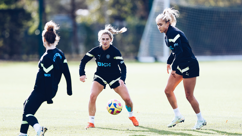 EYES ON THE BALL : Laura Coombs battling for possession