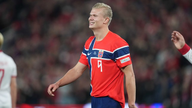 A soccer player wearing an orange Norway national team jersey with the number 9.