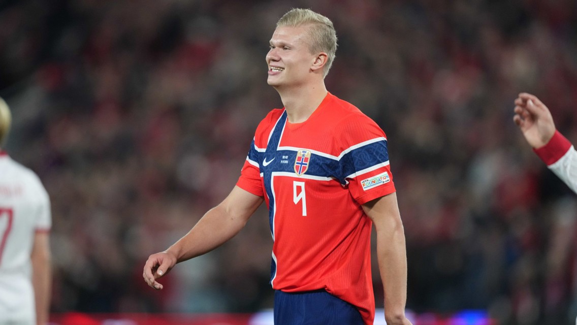 A soccer player wearing an orange Norway national team jersey with the number 9.