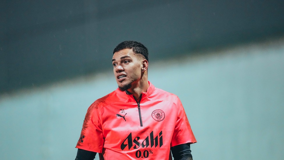IN SAFE HANDS : Ederson makes his way out on to the CFA training pitches. 