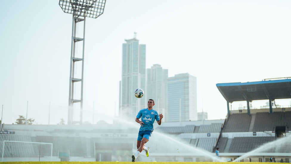 SEOUL MAN : Phil Foden dodges the sprinklers
