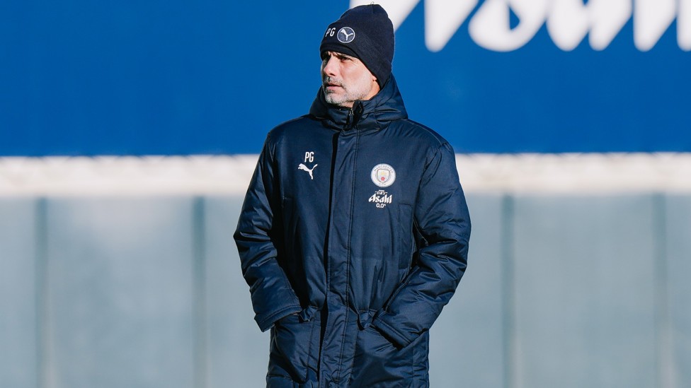 WRAPPED UP : Pep Guardiola watches on under a big coat