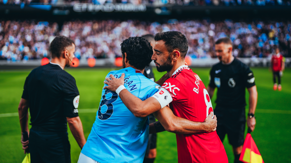 GAME TIME : The skippers greet and the Derby gets underway.