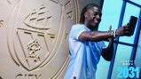 A person wearing a light blue Manchester City jersey taking a selfie in front of the Manchester City emblem. The text 'JEREMY DOKU 2031' is displayed.