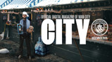 Cover of the December 2025 issue of the Official Digital Magazine of Man City, featuring a person in Man City merchandise holding a doll at a festive market decorated with snow and gifts, showcasing Manchester City logo.