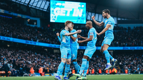 CENTRE OF ATTENTION: KDB is mobbed by his teammates.