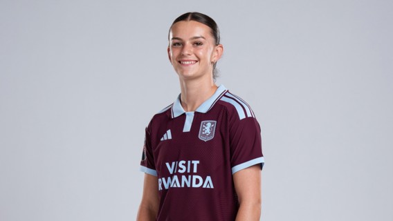 A person wearing an Aston Villa FC jersey in maroon with light blue accents, featuring the 'Visit Rwanda' sponsor and the club crest.