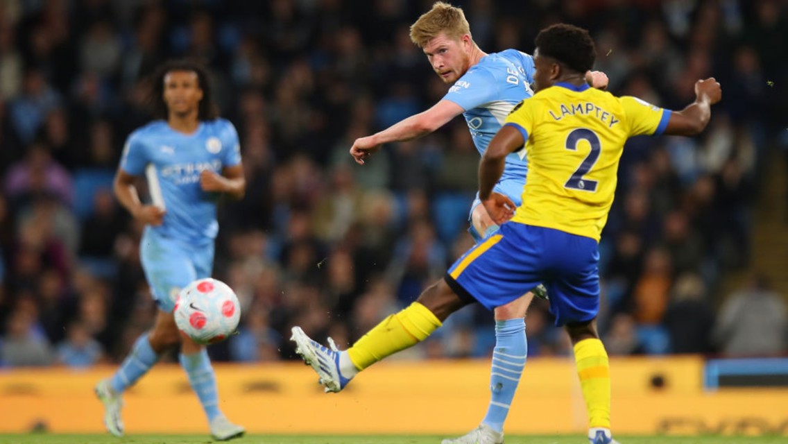 Football match action between Manchester City and Brighton & Hove Albion. Players are interacting with the ball on the field.