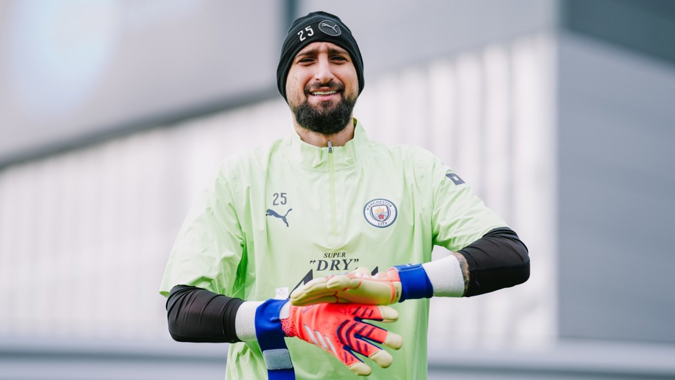 IN SAFE HANDS : Gianluigi Donnarumma makes he way out onto training. 