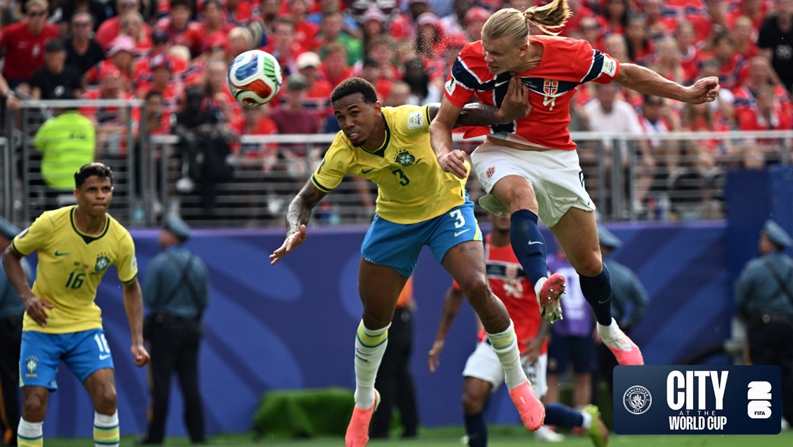 A soccer match featuring players from Brazil and Norway competing for a header. The background shows a crowded stadium with spectators wearing red attire.