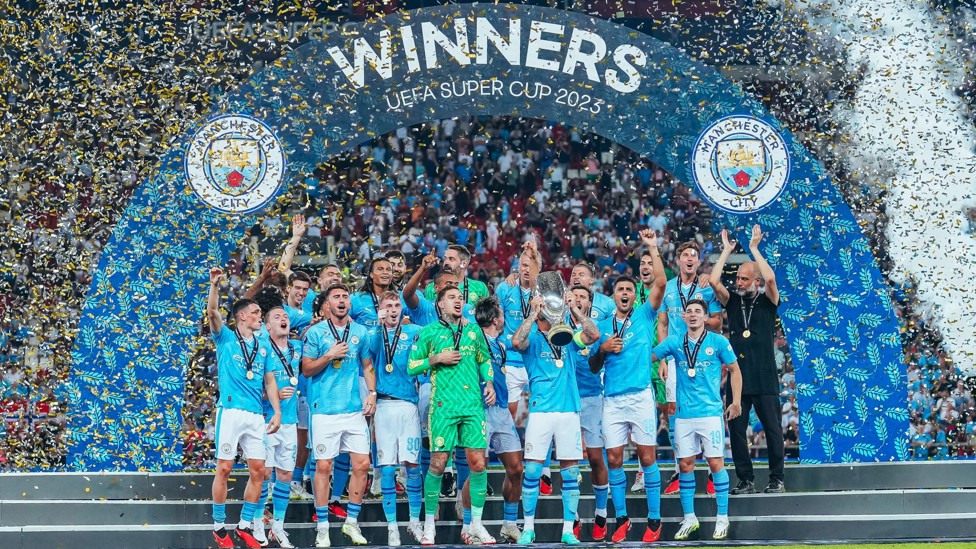 WINNERS : We hold aloft the UEFA Super Cup after a penalties victory over Sevilla in Athens