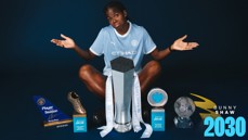 A football player in a Manchester City jersey surrounded by several trophies and awards, including a Golden Boot and Player of the Season.