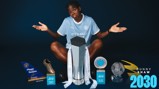 A football player in a Manchester City jersey surrounded by several trophies and awards, including a Golden Boot and Player of the Season.