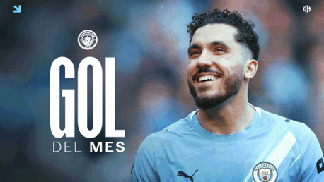 A player in a Manchester City kit with 'GOL DEL MES' text indicating 'Goal of the Month'.