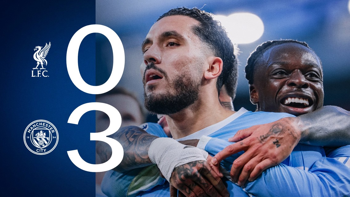 Scoreboard showing Liverpool 0-3 Manchester City with two Manchester City players celebrating.