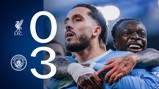 Scoreboard showing Liverpool 0-3 Manchester City with two Manchester City players celebrating.