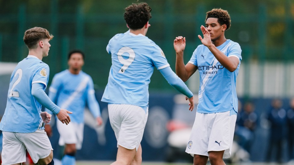 IN FORM : Floyd Samba celebrates his equaliser with Teddie Lamb.