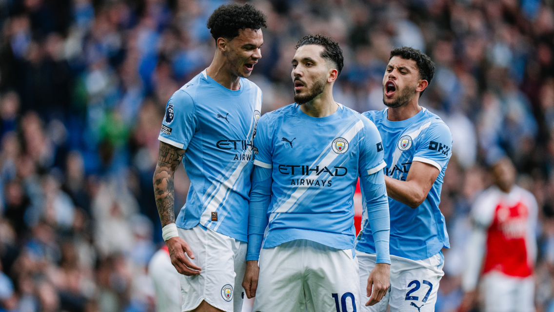 Players wearing Manchester City kit during a match, Etihad Airways sponsor visible.