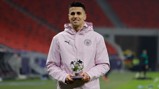 STAR MAN: Cancelo receives his award after a superb display.