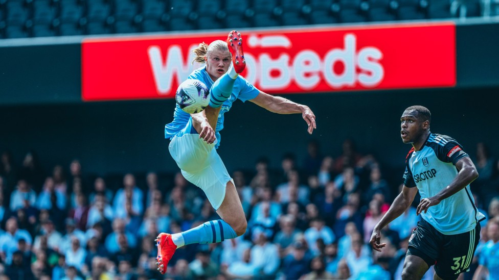 HIGH FLIER : Haaland stretches for the ball.
