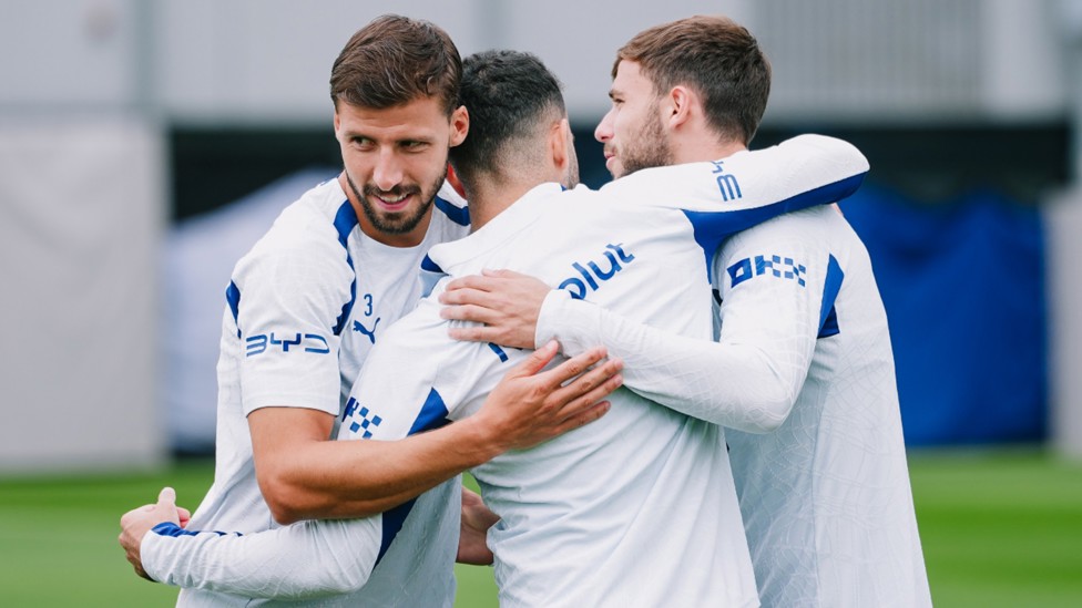 ALL TOGETHER NOW: Hug time for Ruben Dias and Nico Gonzalez.