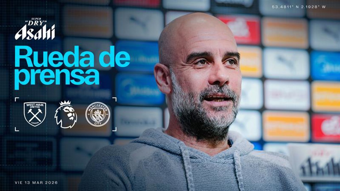 A man speaking at a press conference with event details for a match between West Ham and Manchester City scheduled for Friday 13 March 2026.