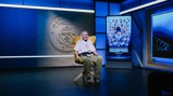 A person seated in a Manchester City studio with a backdrop featuring the club logo and a poster celebrating the Women's Super League champions for the 2025/26 season.