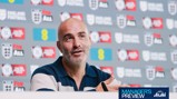 Person speaking at a press conference for England Football, with logos and sponsorships visible in the background.