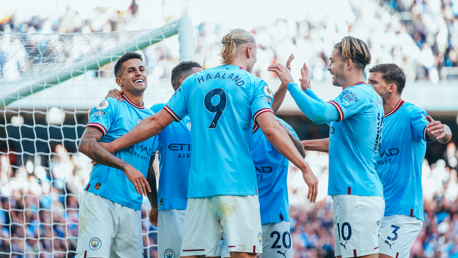 MAIN MAN: The players share the love after Haaland's goal.