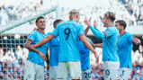 MAIN MAN: The players share the love after Haaland's goal.