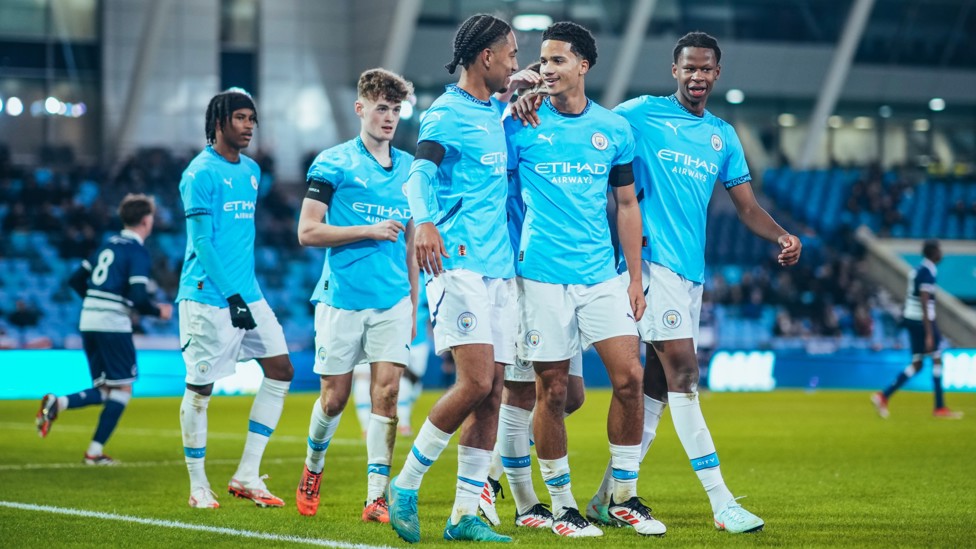 TOGETHER : City celebrate Divine Mukasa's goal.