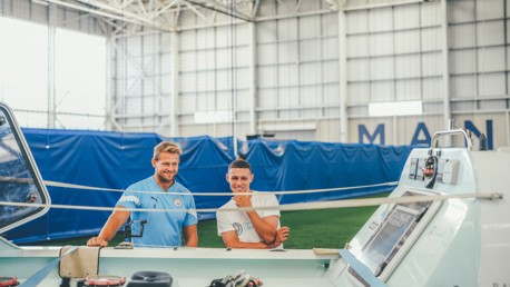 Phil Foden helps Jamie Carr get ready to set sail