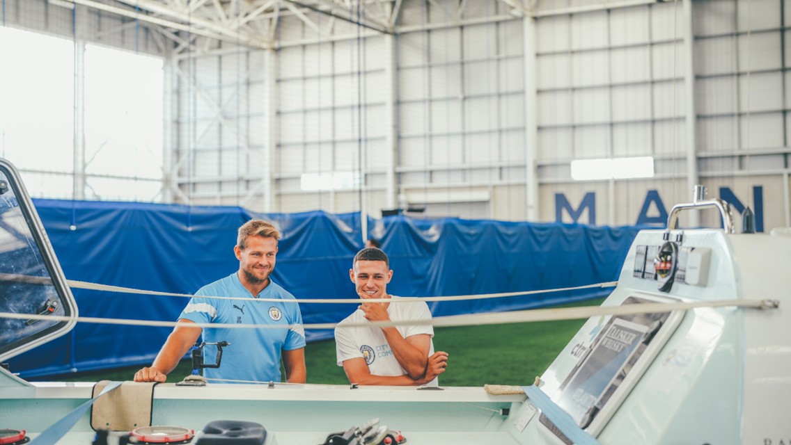 Phil Foden helps Jamie Carr get ready to set sail