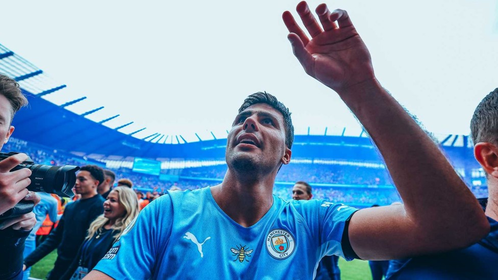 FAN FERVOUR : Rodri acknowledges supporters as he heads off the Etihad pitch after that stunning 2021/22 final day.