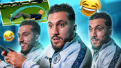 A football player appearing amused during an interview. The background includes a photo of an older man lying on the grass, surrounded by laughing emojis. The player is wearing a Manchester City jacket.